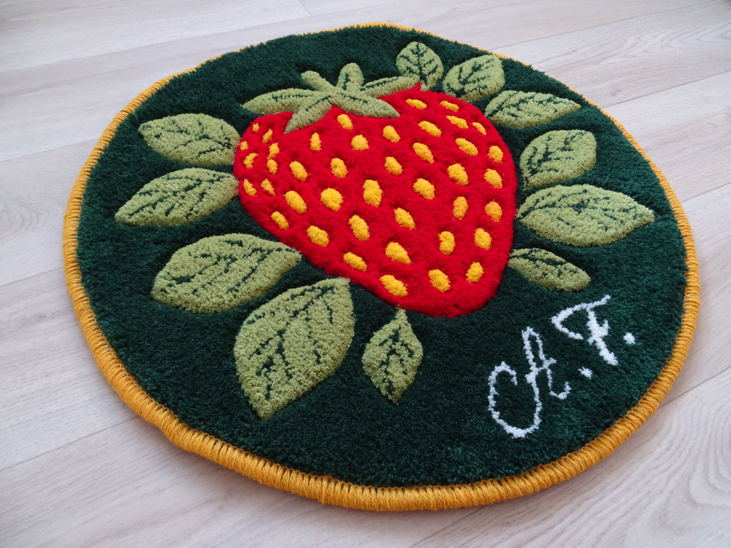 Round hand-tufted wool rug with strawberry motif, personalized with initials, made from natural wool with linen backing.
