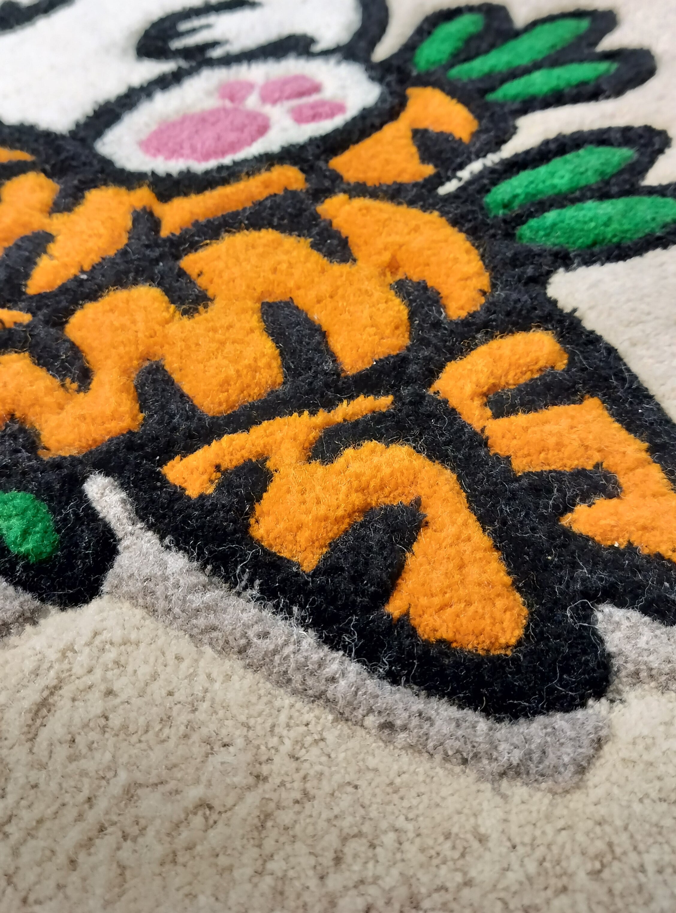 Close-up of handmade personalised wool rug with natural texture and hand-finished details