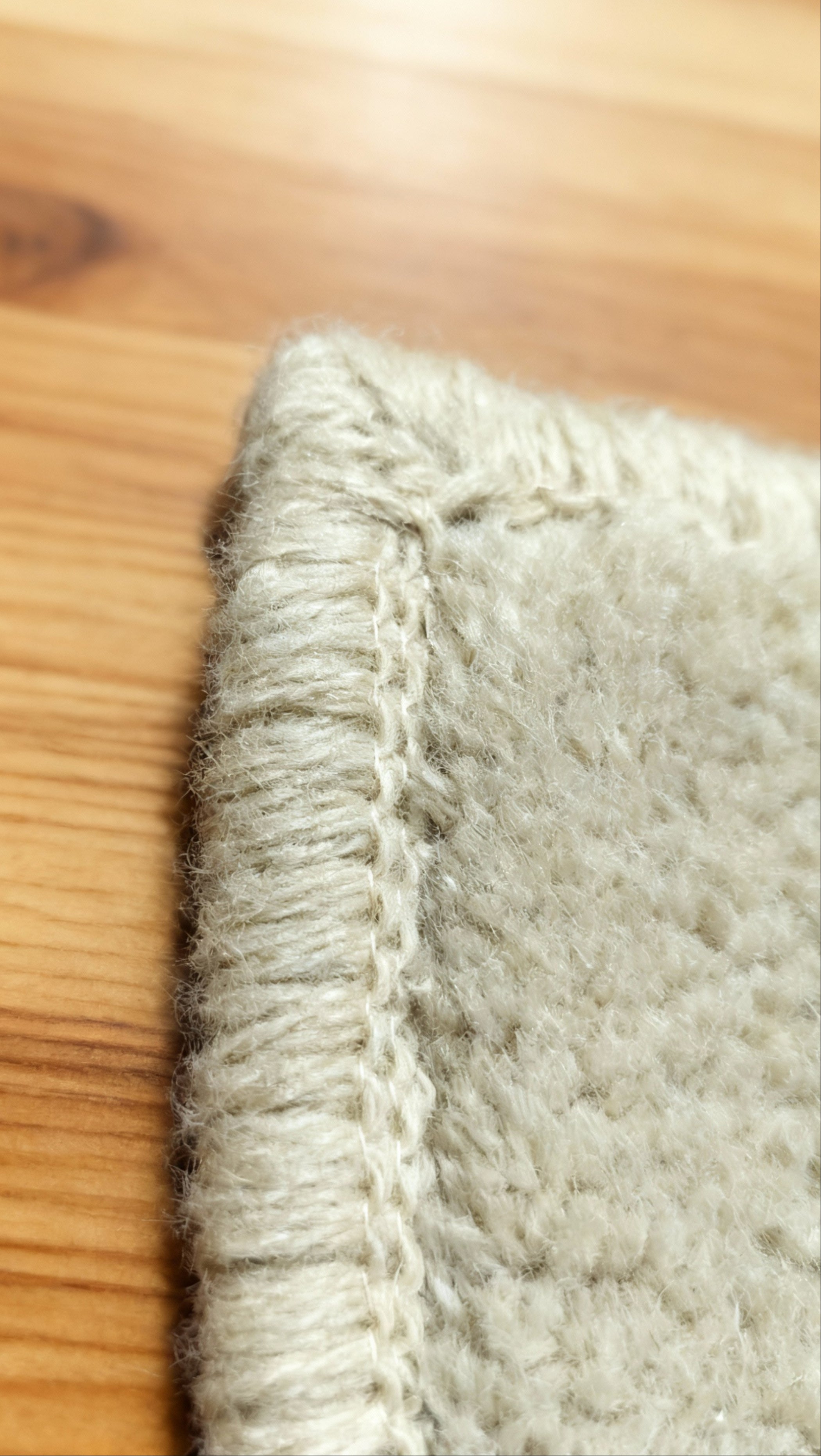 Detail view of a handmade personalised wool rug highlighting natural wool fibres